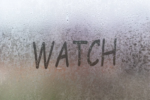 Vidro nebuloso na janela com o dedo escrito palavra relógio — Fotografia de Stock