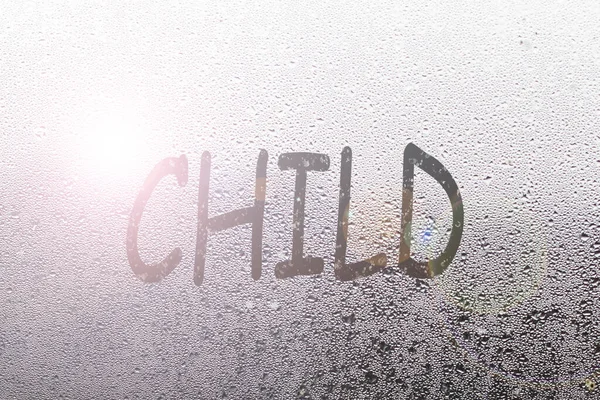 Foggy glass on window with written finger word child overcast wet window — 스톡 사진