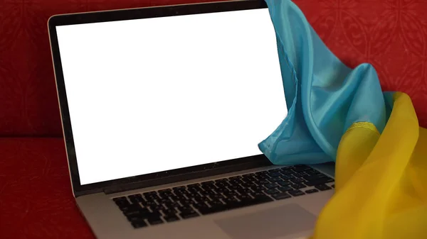 Der leere Laptop-Bildschirm auf dem Hintergrund der Flagge der Ukraine. Kopierraum — Stockfoto