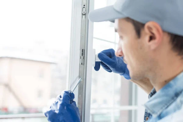 The worker installing and checking window in the house — Stock Photo, Image