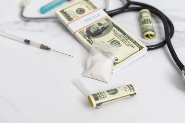 High costs of expensive medication concept , money and stethoscope. — Stock Photo, Image