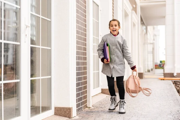 Mooi klein schoolmeisje met een rugzak — Stockfoto