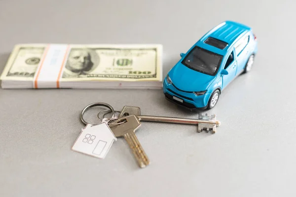 New car with keys and dollar banknotes on white background. — Stock Photo, Image