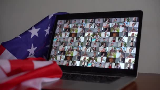 Animation of American flag laptop computer in the background. American society diversity concept digital composition. — ストック動画