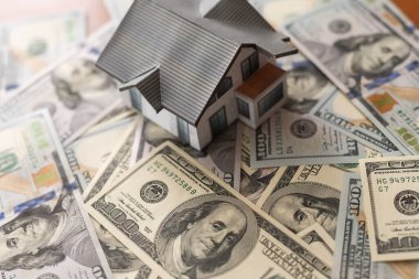 Background from money. Scattered dollars. paper house