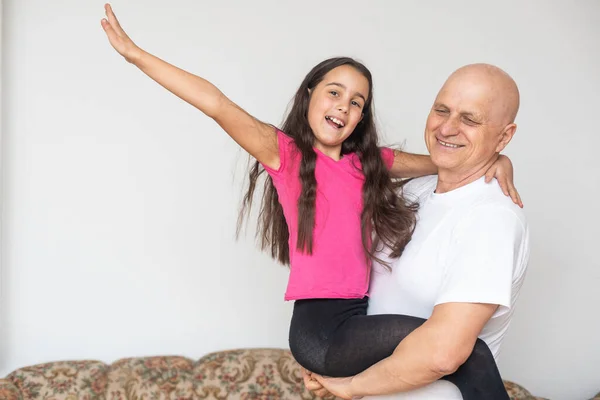 Little granddaughter hugging her grandfather — Stock Photo, Image