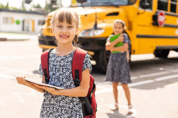 Back to school. First day of school. Two teenage girs at the school feeling happy and excited.