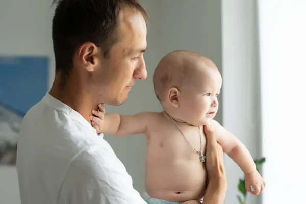 Boldog fiatalember kezében egy mosolygó 6 hónapos baba — Stock Fotó