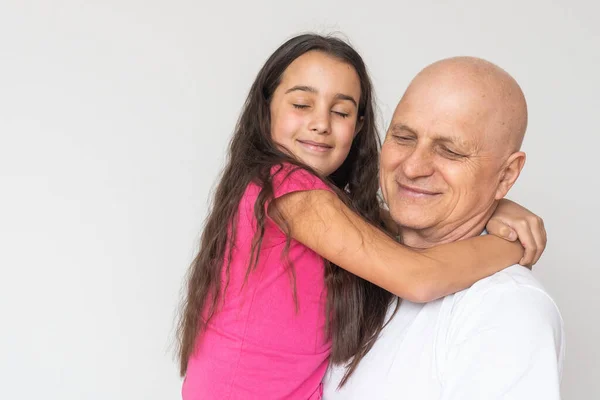 Little granddaughter hugging her grandfather — Stock Photo, Image