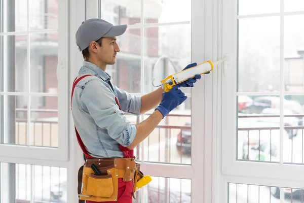 The worker installing and checking window in the house — Stock Photo, Image