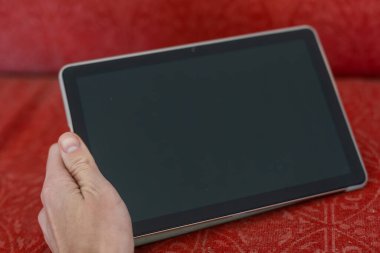 digital tablet on an old couch