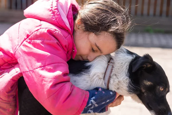 Poor little girl with a dog in village — Fotografia de Stock