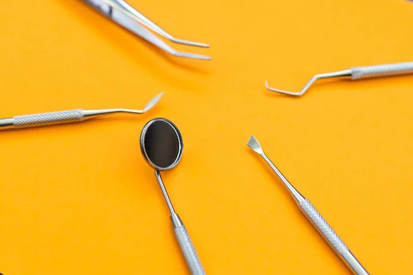 Dentist tools. Teethcare, dental health concept. orange background top view copy space —  Fotos de Stock