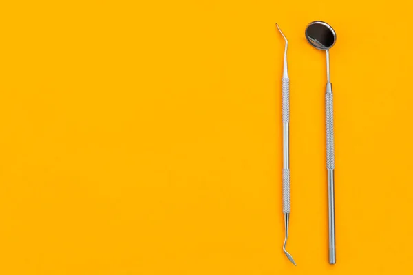 Dental mirror on an orange background. Medical tool —  Fotos de Stock