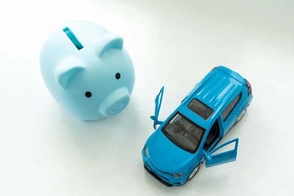 toy car and piggy bank on white background.