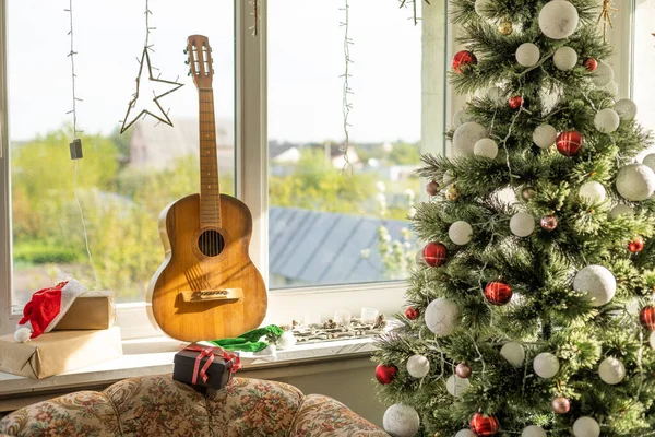 guitar with Christmas presents. Concept image for holiday musical event