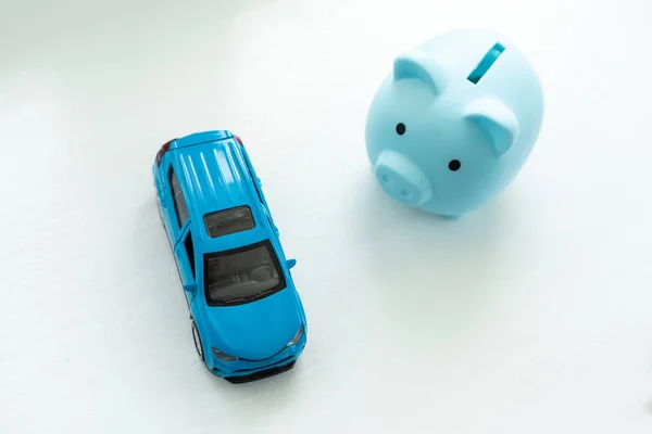 toy car and piggy bank on white background.
