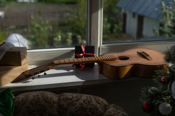 guitar with Christmas presents. Concept image for holiday musical event