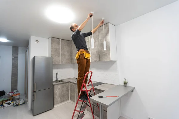 Concept Update Ceiling Lamp Room Happy Man Stepladder Points Ceiling — Stock Photo, Image