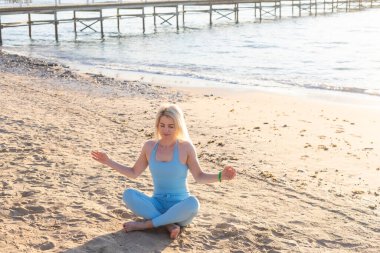Güneş doğarken sahil üzerinde eğitim genç güzel sportif kız