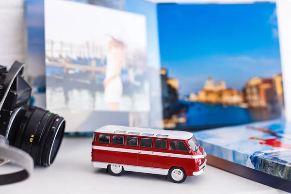 The concept of trip for a travel company. toy bus, plane and photo book, photo album.