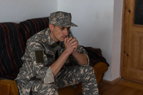 Unhappy Man Camouflage Uniform Sitting Arm Chair White Studio Background — Stock Photo, Image