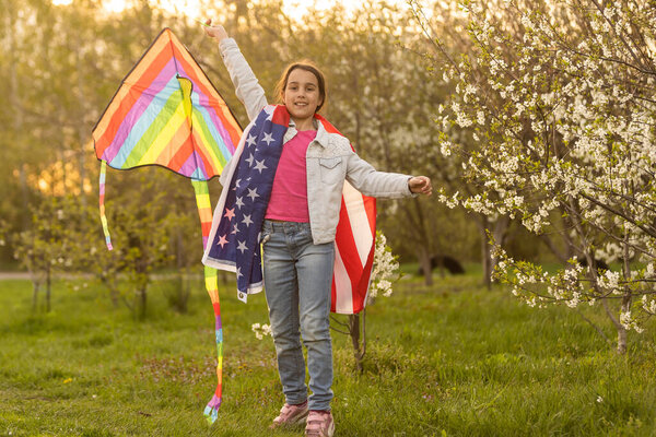 little girl with kite and usa flag.