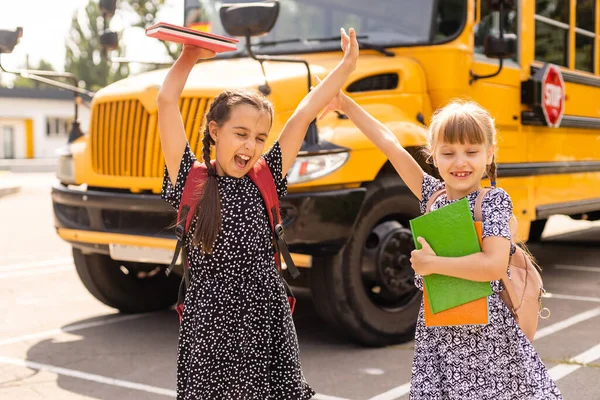 Back to school. First day of school. Two teenage girs at the school feeling happy and excited