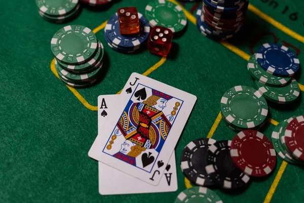 Poker cloth, a deck of cards, poker hand and chips. Background.