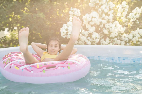 Flicka Spelar Uppblåsbar Ring Poolen Trädgården — Stockfoto