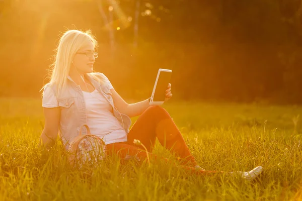 woman with tablet in the park.