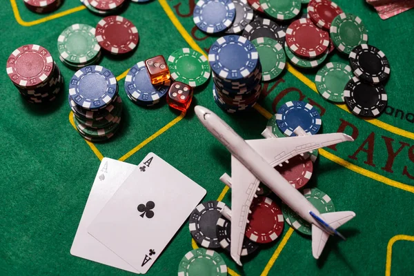 poker chips, money, toy airplane on the blackjack table, casino