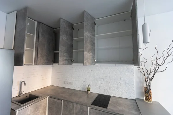 installation of a gray loft kitchen, studio apartment .