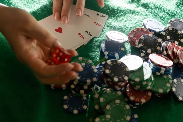 Womens hands shuffle cards. Concept of playing poker on the table with chips and cards. Gambling concept. Enjoying the moment.
