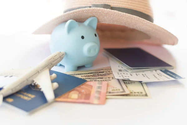Save money for airplane tickets, planning travel budget concept. Airplane model, piggy bank on wooden table.