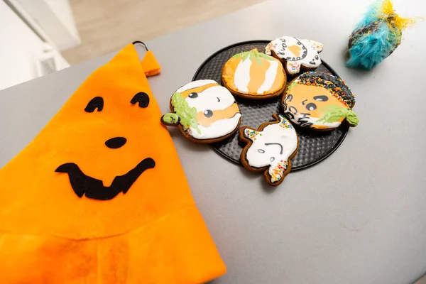 Master class for children on baking funny halloween cookies. Young children learn to cook a funny monster cookies. Kids preparing homemade cookies. Little cook