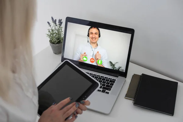 Freelancer, distant working, elearning concept. Young smiling pretty woman worker sitting and looking at laptop screen during videocall, online lecture. Distant learning, connection.