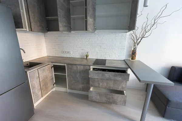 installation of a gray loft kitchen, studio apartment.