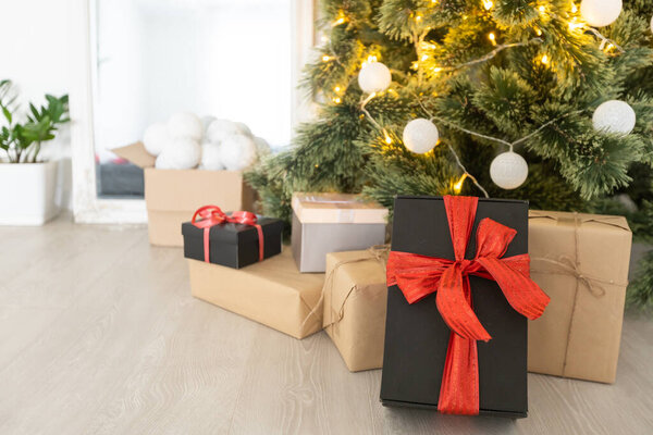 beautiful Christmas gifts under tree in new year decorated house interior.