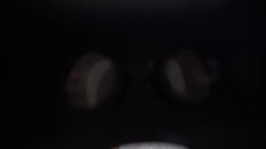 3d glasses watching virtual reality in headwear near xmas tree.