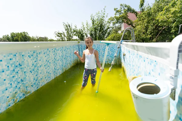 Little Girl Cleans Very Dirty Pool — Photo