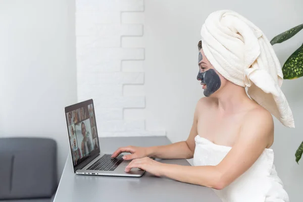 Ung Kvinna Med Handduk Huvudet Och Svart Ansiktslera Mask Sitter — Stockfoto