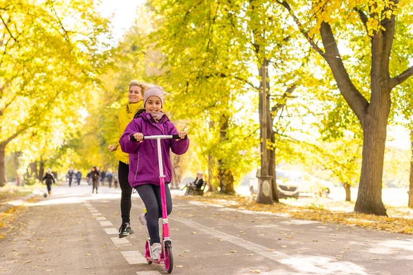 Little Girl Learns Ride Scooter Park Autumn — Foto de Stock