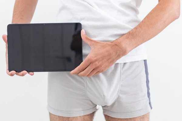 Man Underwear Holding Tablet — Stockfoto