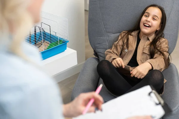 woman school psychologist communicates with a schoolgirl.