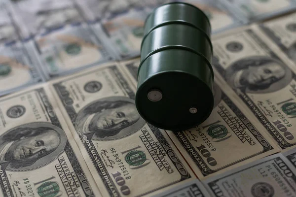 barrels of oil standing on the dollar bills of money. the oil business, purchase sale, production, exchange, trading income