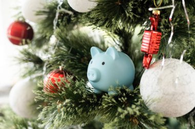 Noel ağacı olan küçük seramik bir kumbara. Yeni yıl hediyelerinin arka planında. 2023 yılının sembolü. Noel kartı.