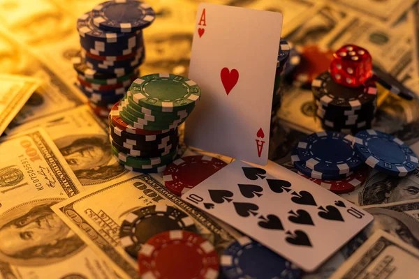 Poker cards royal flush, cash money dollar bills. Gambling, casino chips, dices. Casino tokens, gaming chips, checks, or cheques on green table in casino club.