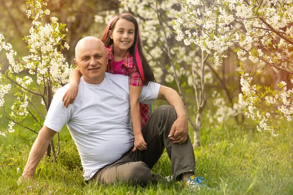 grandfather and granddaughter outdoor in backyard