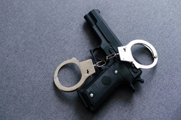 Gun Handcuffs Dark Background — стоковое фото